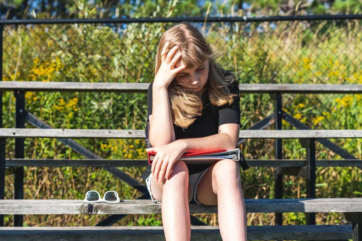 Rising Middle Schooler on Bleachers Middle school athlete sitting on bleachers during youth sports season